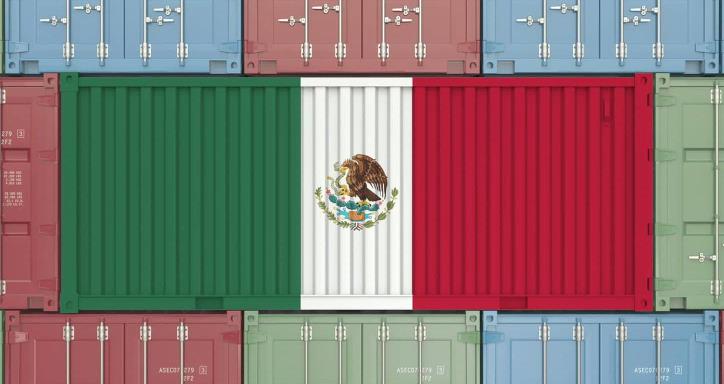 Many shipping containers stacked on top of each other with the middle three containers making the Mexican flag