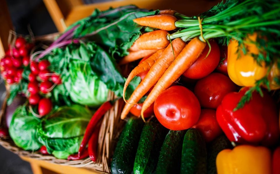 box with carrots, red peppers, cabbage, cucumbers and radishes