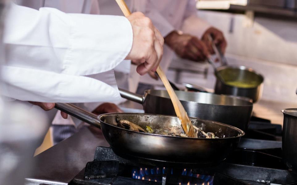 Group of chef preparing food in the kitchen of a restaurant